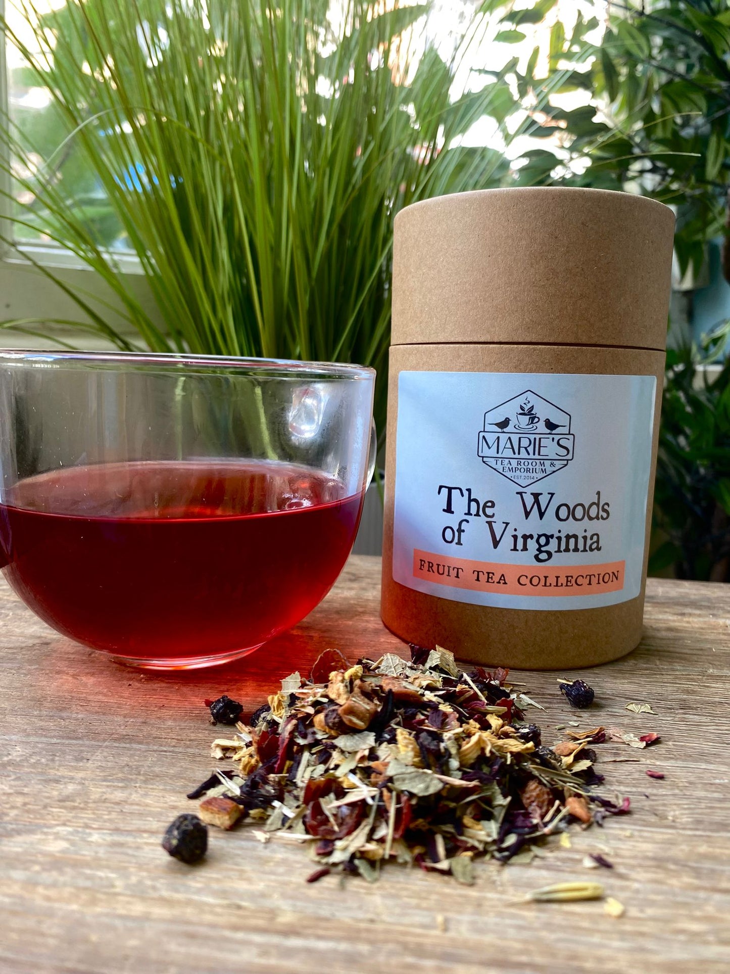 Maries Tea packaging labeled 'The Woods of Virginia' with a glass of tea and tea leaves on a wooden surface.